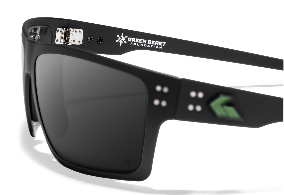 Close-up of Green Beret Foundation x GATORZ Sentix sunglasses showing Green Beret Foundation logo and green GATORZ emblem on the frame