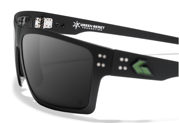 Close-up of Green Beret Foundation x GATORZ Sentix sunglasses showing Green Beret Foundation logo and green GATORZ emblem on the frame